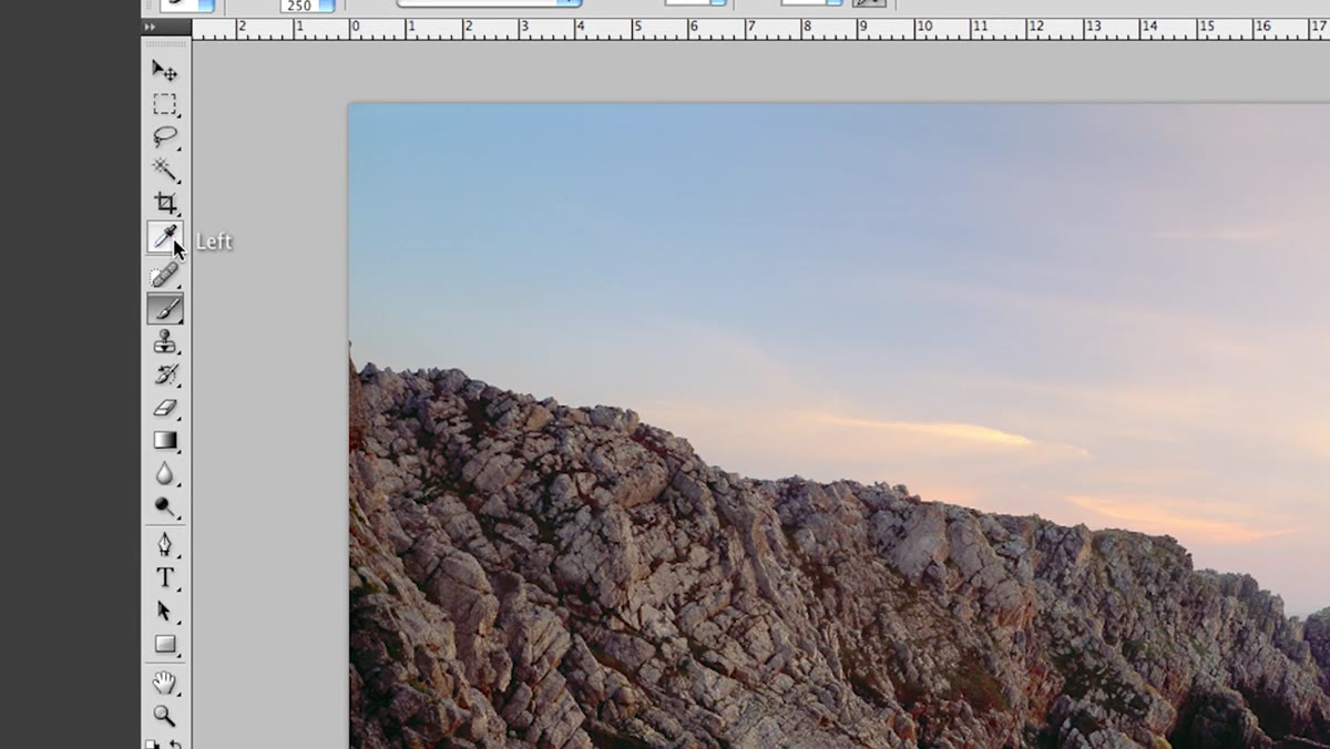 Eyedropper tool sampling warm tone from the rocks