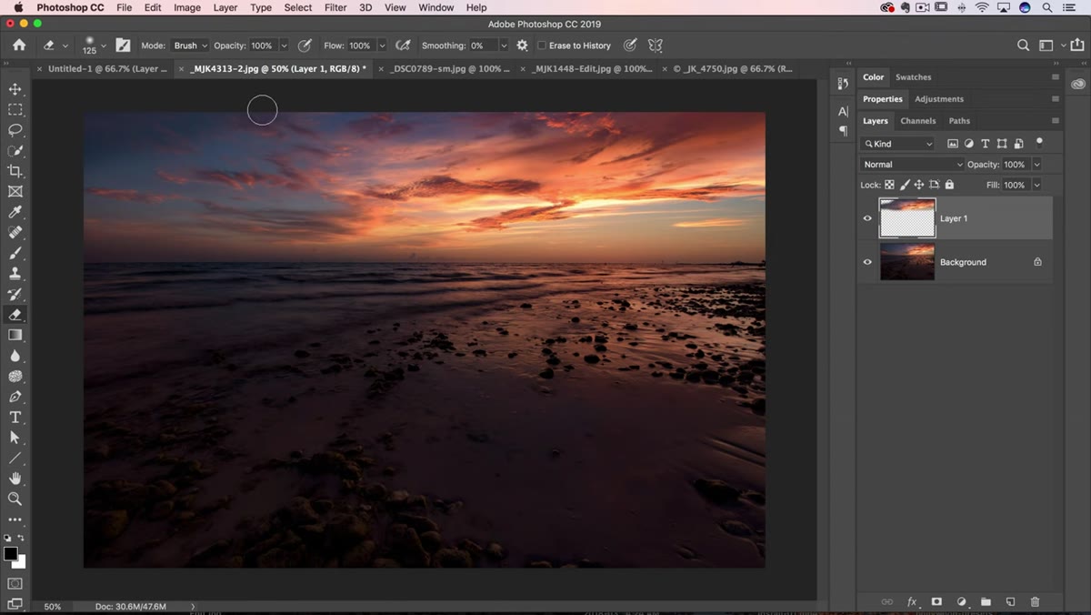 Eraser tool being used at low opacity to soften cloud layer edges
