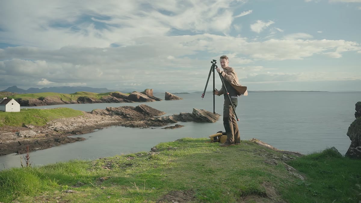Tripod set at half height on rocky shoreline