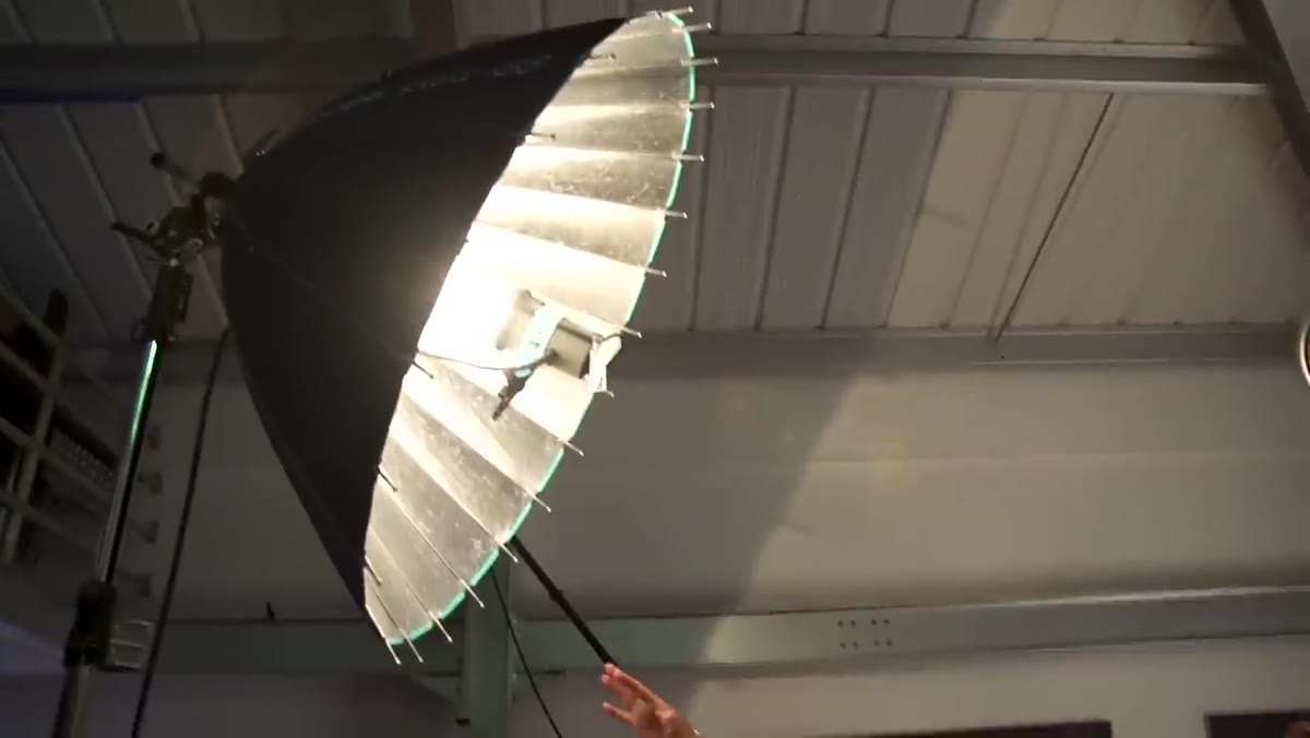 Studio beauty lighting rig with para reflector and hair light visible