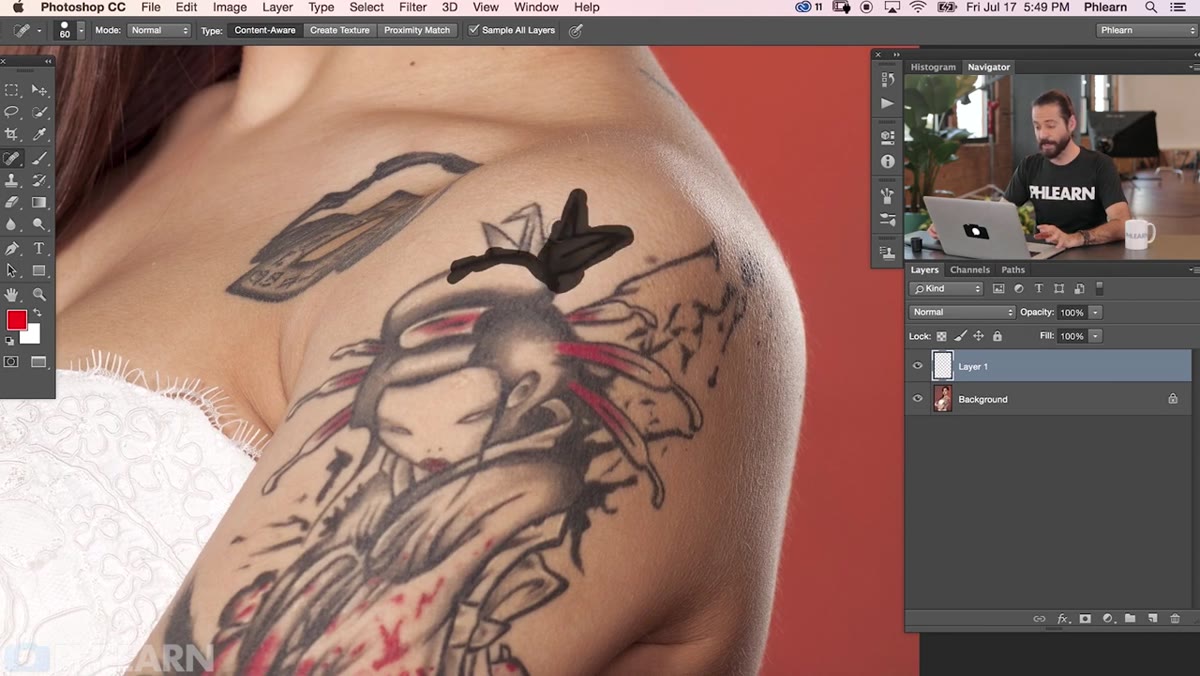 Spot Healing Brush being painted over tattoo area in small strokes